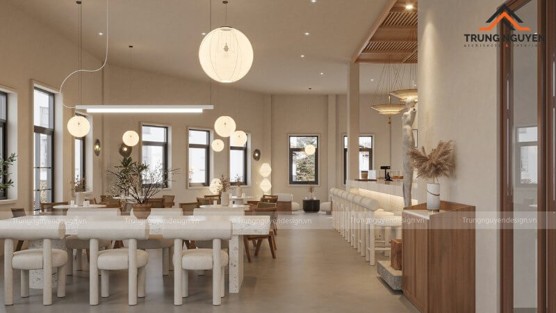 Không gian quán cafe Wabi-Sabi với đèn vàng ấm áp chiếu xuống bàn gỗ, tạo nên những vùng sáng tối tinh tế