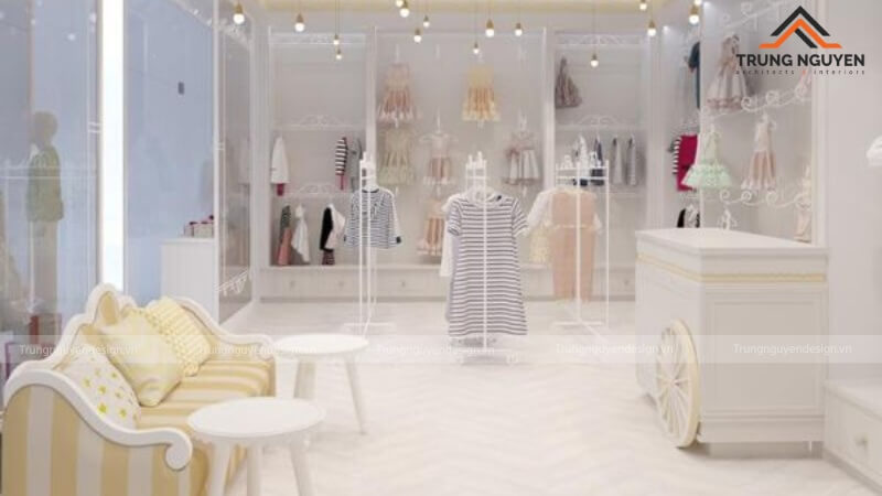 Shop thời trang trẻ em phong cách hiện đại với gam màu trắng và gỗ sáng, kệ trưng bày tối giản